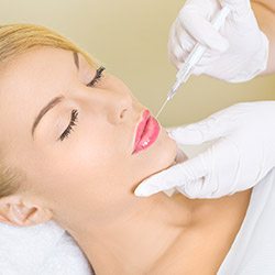 woman getting filler injection in her face