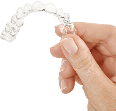 Hand holding an Invisalign clear aligner