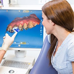 dentist showing patient a digital scan of their teeth