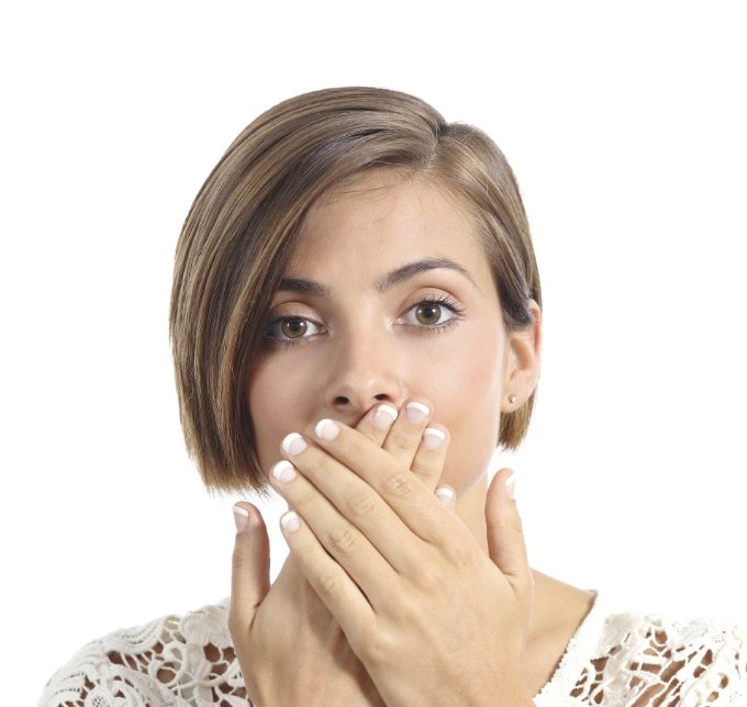 Woman covering her mouth with both hands