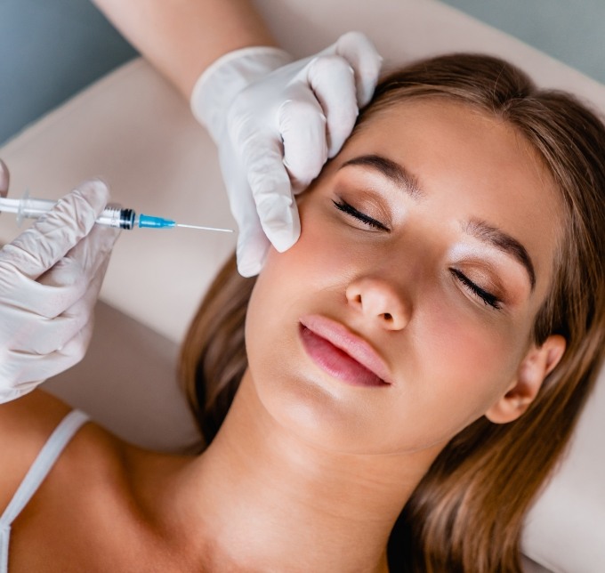 Woman leaning back in dental chair receiving Botox in Albuquerque