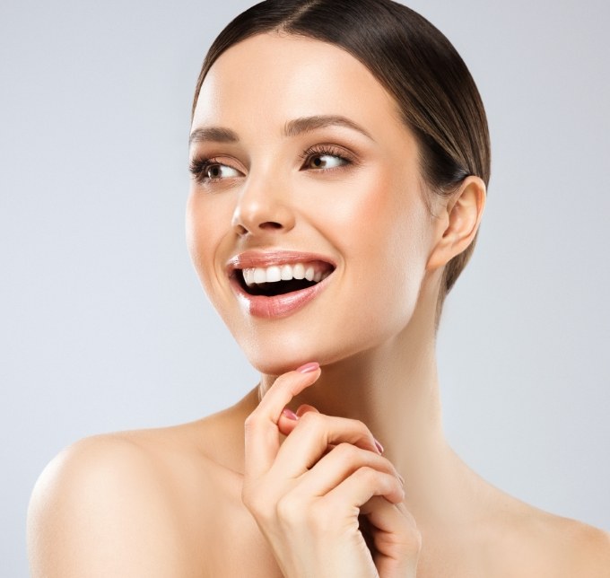 Woman with smooth skin standing and smiling