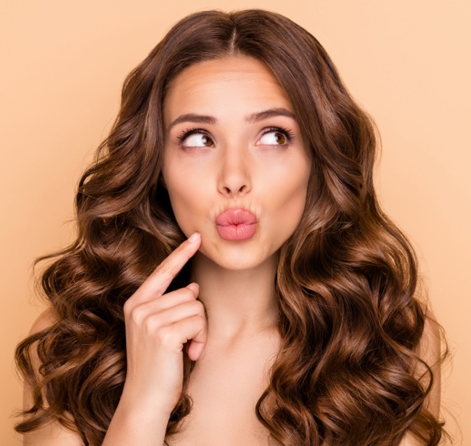 Woman standing with her lips pursed