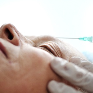 An older woman having Botox to remove forehead wrinkles