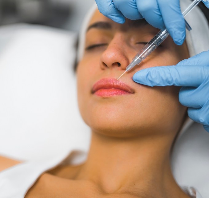 An older woman having Botox to remove forehead wrinkles