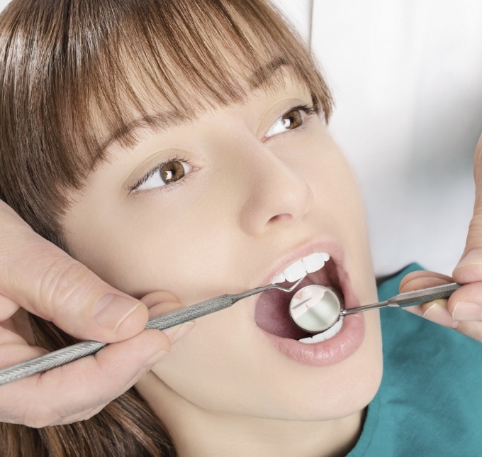 Checking teeth with dental instruments during dental checkup in Albuquerque