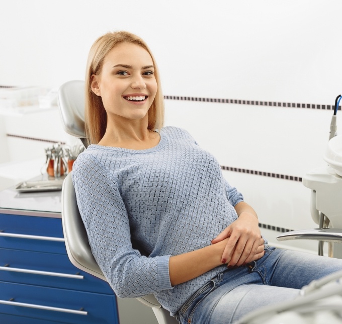 Woman leaning back in chair and smiling