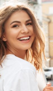 Blonde woman looking back and smiling