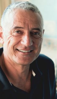 Man with short grey hair smiling