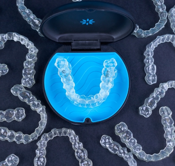 Clear aligner for Invisalign in Albuquerque in case surrounded by many aligners