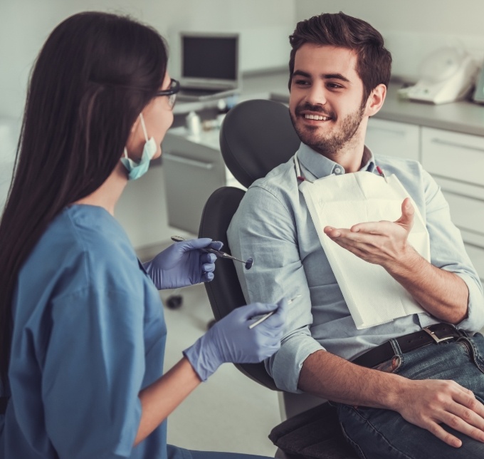 Bearded man speaking to a female dentist