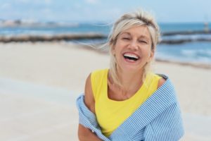 a woman smiling on the beach