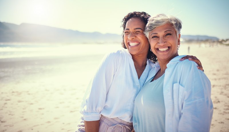 two women smiling on the beach